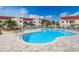 Resort-style community pool with lounge chairs and well-maintained landscaping with multi-story buildings at 6077 Bahia Del Mar Blvd # 123, St Petersburg, FL 33715
