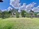 A beautifully landscaped backyard is enclosed by a decorative iron fence at 6293 Bradford Woods Dr, Zephyrhills, FL 33542