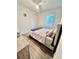 Cozy bedroom with window, complemented by stylish decor and hardwood floors, creating a comfortable retreat at 6293 Bradford Woods Dr, Zephyrhills, FL 33542
