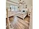 Bright bedroom with a ceiling fan, tray ceiling, and large windows, providing ample natural light at 6293 Bradford Woods Dr, Zephyrhills, FL 33542