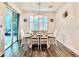 Well-lit dining area featuring wood floors and sliding glass doors with outdoor access at 6293 Bradford Woods Dr, Zephyrhills, FL 33542