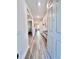 Bright and airy hallway featuring stylish flooring, modern decor, and easy access to living spaces at 6293 Bradford Woods Dr, Zephyrhills, FL 33542