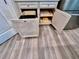 Kitchen base cabinets offer pull-out trash can and storage for cookware and kitchen accessories at 6293 Bradford Woods Dr, Zephyrhills, FL 33542