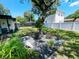 Spacious backyard with landscaping, white fence and mature tree at 7101 N 9Th St, Tampa, FL 33604