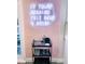 Stylish bar cart featuring a neon sign, glassware, and bar tools, perfect for entertaining at 7101 N 9Th St, Tampa, FL 33604