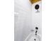 Crisp white bathroom with a matte black shower head and fixtures for a modern aesthetic at 7101 N 9Th St, Tampa, FL 33604