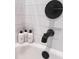 Modern bathroom with sleek black faucet fixtures, white tile, and designer shampoo bottles at 7101 N 9Th St, Tampa, FL 33604