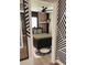 The bedroom, seen through a geometric-wallpapered hallway, offers a cozy and stylish retreat at 7101 N 9Th St, Tampa, FL 33604
