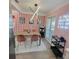 Stylish dining room with a modern light fixture, chic chairs, and a trendy bar cart at 7101 N 9Th St, Tampa, FL 33604