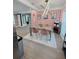 Open-concept dining area showcasing modern lighting, stylish chairs, and artistic wallpaper at 7101 N 9Th St, Tampa, FL 33604