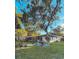 Charming home with a well-maintained lawn, mature trees, and modern fence at 7101 N 9Th St, Tampa, FL 33604