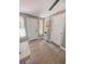 Hallway with hard surface flooring and a decorative ladder shelf with plants at 7101 N 9Th St, Tampa, FL 33604