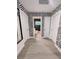 Hallway showcasing a unique geometric wallpaper pattern, doorways, and modern interior design at 7101 N 9Th St, Tampa, FL 33604