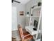 Bright home office setup with white ladder shelf, modern desk, and comfortable brown leather chair at 7101 N 9Th St, Tampa, FL 33604