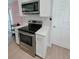 Updated kitchen with stainless steel appliances, white cabinets, and subway tile backsplash at 7101 N 9Th St, Tampa, FL 33604