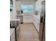 Bright kitchen with stainless steel appliances, white cabinetry, and subway tile backsplash at 7101 N 9Th St, Tampa, FL 33604