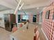 Inviting interior view showing open floor plan with trendy decor, contemporary lighting, and eat in kitchen at 7101 N 9Th St, Tampa, FL 33604