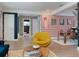 Open living space with playful wallpaper, a unique accent chair, and seamless flow to dining area at 7101 N 9Th St, Tampa, FL 33604