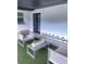 Outdoor patio area with modern furniture and a black framed double door at 7101 N 9Th St, Tampa, FL 33604