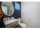 A stylish half-bathroom features a vanity with marble countertop, oval mirror, and modern fixtures at 805 100Th N Ave, St Petersburg, FL 33702