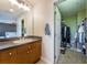 Bathroom with vanity and mirror, located near the closet, offering convenience and style at 805 100Th N Ave, St Petersburg, FL 33702