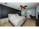 Spacious bedroom with a ceiling fan, two windows, and a dark accent wall at 805 100Th N Ave, St Petersburg, FL 33702