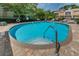 Refreshing community pool with a clear blue water, a stainless steel handrail, and well maintained surrounding area at 805 100Th N Ave, St Petersburg, FL 33702