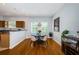 Bright dining area with hardwood floors and an open layout to the kitchen at 805 100Th N Ave, St Petersburg, FL 33702