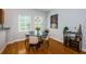 Charming dining area with hardwood floors, stylish lighting, and large windows at 805 100Th N Ave, St Petersburg, FL 33702