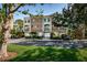 Charming multi-story townhouse complex with well-manicured lawn, lush trees, and brick-paved driveways at 805 100Th N Ave, St Petersburg, FL 33702