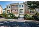 Townhouse exterior boasts a Mediterranean style, private balconies, attached garage, and vibrant landscaping at 805 100Th N Ave, St Petersburg, FL 33702
