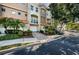 Charming townhome with attached garage, well-maintained landscaping, and a brick driveway at 805 100Th N Ave, St Petersburg, FL 33702