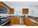 Traditional style kitchen with granite countertops, stainless steel appliances, and wood cabinetry at 805 100Th N Ave, St Petersburg, FL 33702