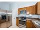 Traditional kitchen with stainless steel appliances, granite countertops, and light-colored cabinets at 805 100Th N Ave, St Petersburg, FL 33702