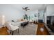 A bright living room with hardwood floors, ceiling fan and comfortable white couch with modern decor at 805 100Th N Ave, St Petersburg, FL 33702
