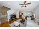 Bright living room with hardwood floors, neutral walls, fan, and modern furniture, open to dining area at 805 100Th N Ave, St Petersburg, FL 33702