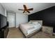 Spacious main bedroom with a dark accent wall, ceiling fan, and carpeted floor at 805 100Th N Ave, St Petersburg, FL 33702