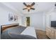 Light-filled bedroom with private balcony, ceiling fan, neutral tones, and cozy carpeting at 805 100Th N Ave, St Petersburg, FL 33702
