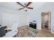 This bedroom has a ceiling fan, carpeted floors, an office desk, and an ensuite bathroom at 805 100Th N Ave, St Petersburg, FL 33702