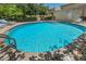 Community pool with sunny deck featuring lounge chairs at 805 100Th N Ave, St Petersburg, FL 33702