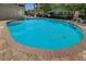 Community outdoor pool with stairs, railings, chairs and a life preserver at 805 100Th N Ave, St Petersburg, FL 33702