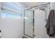 The walk-in shower has glass doors and is enclosed with white tiled walls, offering a clean look at 805 100Th N Ave, St Petersburg, FL 33702