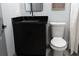 Modern bathroom featuring a black vanity with granite countertop and a standard white toilet at 8303 N 17Th St, Tampa, FL 33604