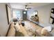 Bright living room with neutral furniture, ceiling fan, light wood floors, front door, and stylish decor at 8303 N 17Th St, Tampa, FL 33604