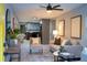 Open-concept living room with modern furnishings, wood floors, gray accents, and open to the kitchen at 8303 N 17Th St, Tampa, FL 33604