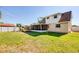 Large backyard featuring a screened patio, play equipment, and ample green space at 8798 94Th St, Seminole, FL 33777