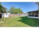Spacious backyard with lush green grass and a storage shed at 8798 94Th St, Seminole, FL 33777