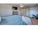 Spacious bedroom with carpeted floors, neutral walls, a TV, and ample closet space at 8798 94Th St, Seminole, FL 33777