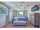 Bright bedroom boasts two windows, a dresser, and a bed with a sitting bench for comfort and style at 8798 94Th St, Seminole, FL 33777