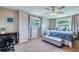 Relaxing bedroom features two windows, a sitting bench, desk space, and ample natural light at 8798 94Th St, Seminole, FL 33777